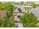 This aerial shot displays a home with solar panels on the roof, a manicured yard, and a view of the neighborhood at 11130 Summer Star Dr, Riverview, FL 33579