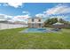 Backyard featuring a swimming pool and patio area complete with lounge chairs and an umbrella at 11130 Summer Star Dr, Riverview, FL 33579