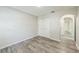 Bright, airy bedroom featuring stylish wood-look floors and a closet for ample storage at 11130 Summer Star Dr, Riverview, FL 33579