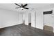 Primary bedroom featuring ceiling fan, gray wood flooring, and ensuite bathroom at 11130 Summer Star Dr, Riverview, FL 33579