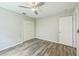 Cozy bedroom featuring a ceiling fan, stylish wood-look floors, and a closet for ample storage at 11130 Summer Star Dr, Riverview, FL 33579