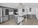 Bright kitchen featuring gray cabinets, stainless appliances, and island with marble countertop at 11130 Summer Star Dr, Riverview, FL 33579