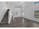 Bright living room with gray wood floors, staircase, high ceilings and bright windows at 11130 Summer Star Dr, Riverview, FL 33579