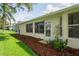 Cozy backyard showcasing a well-maintained lawn and mature landscaping, complete with rear screened windows at 11412 Alden Ct, Hudson, FL 34667