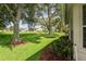 Expansive backyard with lush lawn, bordered by mature trees and landscaping, perfect for outdoor enjoyment at 11412 Alden Ct, Hudson, FL 34667
