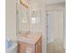 Comfortable bathroom featuring a vanity with a large mirror and tiled flooring at 11412 Alden Ct, Hudson, FL 34667