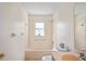 Bright bathroom with a shower-tub, vanity, and tile flooring at 11412 Alden Ct, Hudson, FL 34667