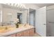 Bathroom featuring a double vanity with adjacent shower and extra doorway at 11412 Alden Ct, Hudson, FL 34667