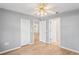 Bedroom features wood floors, neutral paint and open doorway at 11412 Alden Ct, Hudson, FL 34667
