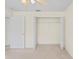 Bedroom featuring a closet and neutral carpet at 11412 Alden Ct, Hudson, FL 34667