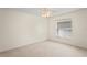 Bright bedroom featuring neutral carpet and a window offering natural light at 11412 Alden Ct, Hudson, FL 34667