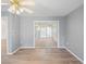 Bedroom features neutral walls, vinyl floors, ceiling fan, and sliding glass doors to the lanai at 11412 Alden Ct, Hudson, FL 34667