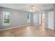 Spacious bedroom features wood floors, neutral paint, ceiling fan, and bright windows at 11412 Alden Ct, Hudson, FL 34667