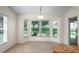 Sunny breakfast nook with large bay windows, offering a lovely view of the backyard at 11412 Alden Ct, Hudson, FL 34667