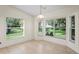 Bright breakfast nook featuring large windows overlooking the lush outdoor landscape at 11412 Alden Ct, Hudson, FL 34667