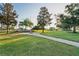 Scenic community park featuring lush green lawns, mature trees, and a paved walkway leading to a memorial at 11412 Alden Ct, Hudson, FL 34667