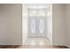 Inviting foyer with tile flooring, a decorative door, and high ceilings at 11412 Alden Ct, Hudson, FL 34667