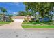 Charming single-story home with manicured lawn, double door entry, and attached two-car garage at 11412 Alden Ct, Hudson, FL 34667