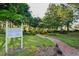 Beautiful Garden Park featuring a lush green lawn, a brick pathway, and various plants and trees at 11412 Alden Ct, Hudson, FL 34667