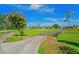 Picturesque view of a golf course with a small bridge surrounded by lush greenery and blue skies at 11412 Alden Ct, Hudson, FL 34667