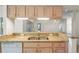 Kitchen features granite countertops, wood cabinets, stainless steel sink, and views to living areas at 11412 Alden Ct, Hudson, FL 34667