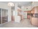 Open kitchen with granite countertops, wood cabinets, white appliances, and a view to another room at 11412 Alden Ct, Hudson, FL 34667