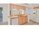 Kitchen boasts granite countertops, wood cabinets, stainless steel sink, and a view to another room at 11412 Alden Ct, Hudson, FL 34667