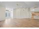 Open-concept living room with wood-look floors and direct access to the kitchen at 11412 Alden Ct, Hudson, FL 34667