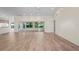 Spacious living room with modern wood-look floors, ceiling fans, and natural light at 11412 Alden Ct, Hudson, FL 34667