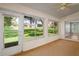 Spacious sunroom with large windows offering views of the backyard at 11412 Alden Ct, Hudson, FL 34667