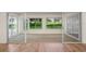 Relaxing sunroom featuring sliding glass doors and wood flooring at 11412 Alden Ct, Hudson, FL 34667