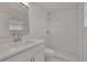 Bright bathroom featuring a new vanity with a quartz countertop and a shower with white subway tile at 1207 Chevy Chase Dr, Sun City Center, FL 33573