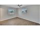 Light and bright bedroom featuring wood-look flooring, large windows and a ceiling fan at 1207 Chevy Chase Dr, Sun City Center, FL 33573