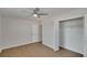 Spacious bedroom featuring wood-look floors, a large window and a closet with sliding doors at 1207 Chevy Chase Dr, Sun City Center, FL 33573