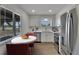 Modern kitchen with stainless appliances, breakfast nook, and bright natural lighting at 1207 Chevy Chase Dr, Sun City Center, FL 33573