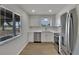 Modern kitchen featuring stainless steel appliances, bright lighting, and stylish backsplash at 1207 Chevy Chase Dr, Sun City Center, FL 33573