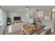 Open-concept living area with modern furniture, dining table and view into the kitchen at 1207 Chevy Chase Dr, Sun City Center, FL 33573