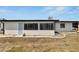 View of the rear of the home with enclosed lanai and easy access door at 1207 Chevy Chase Dr, Sun City Center, FL 33573