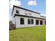 Exterior of the house with covered patio and ample windows, surrounded by a lush green lawn at 12758 Oak Hill Way, Parrish, FL 34219