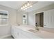 Bright bathroom featuring double vanity, quartz countertop, and a large mirror at 12758 Oak Hill Way, Parrish, FL 34219