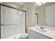 Bathroom with tiled shower, quartz countertop, and a large mirror at 12758 Oak Hill Way, Parrish, FL 34219
