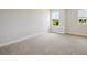 Bedroom with neutral carpet, fresh paint, and bright windows at 12758 Oak Hill Way, Parrish, FL 34219