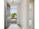 Welcoming entryway with open door leading to tiled walkway and beautifully landscaped exterior at 12758 Oak Hill Way, Parrish, FL 34219