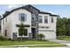 Beautiful two-story home with stone accents, shutters, well-manicured lawn, and a two-car garage at 12758 Oak Hill Way, Parrish, FL 34219
