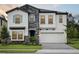 Stunning two-story house with stone detailing, shutters, two-car garage, and manicured landscaping at 12758 Oak Hill Way, Parrish, FL 34219