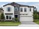 Beautiful two-story home with a stone facade and well-manicured lawn offers great curb appeal at 12758 Oak Hill Way, Parrish, FL 34219