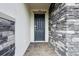 Stylish front door framed by a stone wall and pavers at 12758 Oak Hill Way, Parrish, FL 34219