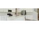 Modern kitchen featuring stainless steel appliances, quartz countertops, and ample cabinet space at 12758 Oak Hill Way, Parrish, FL 34219