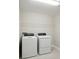 Bright laundry room features a white washer and dryer, complemented by a wire shelf at 12758 Oak Hill Way, Parrish, FL 34219