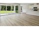 Open living room with wood floors and sliding glass doors leading to covered patio at 12758 Oak Hill Way, Parrish, FL 34219